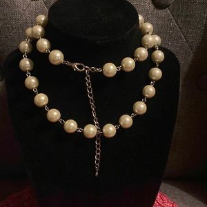 Faux pearls individually linked on silver tone chain.